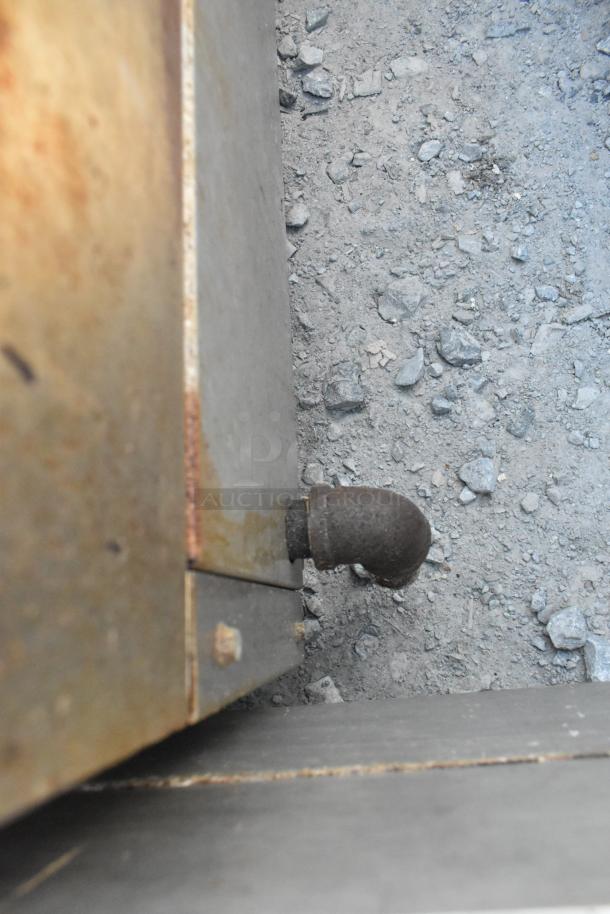 Cook Rite stainless steel commercial charbroiler gas connection detail; outdoor, used condition.