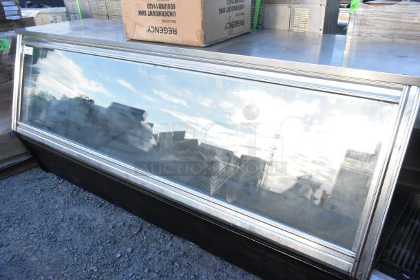 Metal commercial refrigerated deli display case with glass front, in used condition. Ideal for showcasing perishables.