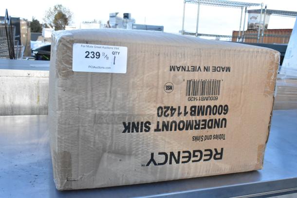 Brand new Regency 600UMB11420 14"x16"x10" stainless steel undermount sink in original packaging, visible shipping labels.