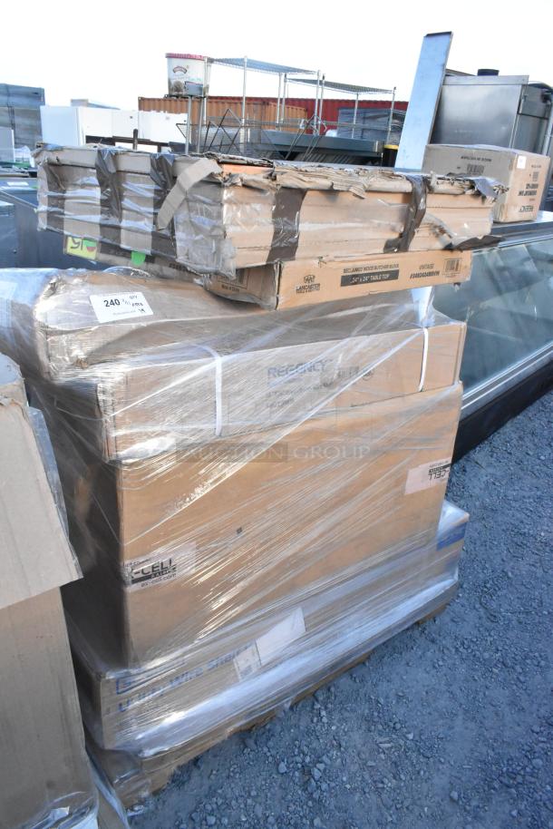 Stack of boxed scratch and dent items including a tabletop and wall shelf, wrapped in plastic. Boxes show minor wear.