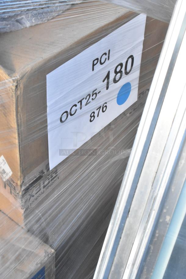 Stacked new auction items, including a tabletop and wall shelf, wrapped with a label marked "PCI OCT25-180 876."