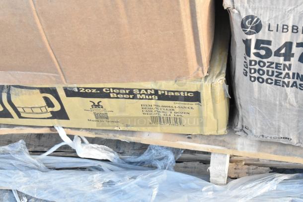 Boxes labeled "12oz. Clear SAN Plastic Beer Mug" and "LIBBEY 154" on a pallet, new condition, includes 20 items.