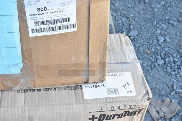 Cardboard boxes showing labels for Libbey DuraTuff glasses and Cebreaker lids, indicating contents and weight.