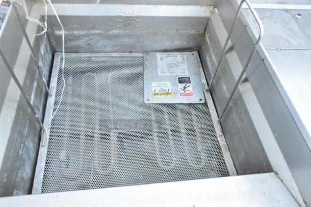 Giles EOF-24 stainless steel 3 bay deep fat fryer with dumping station, visible wear, commercial casters, 480V, 3 phase.