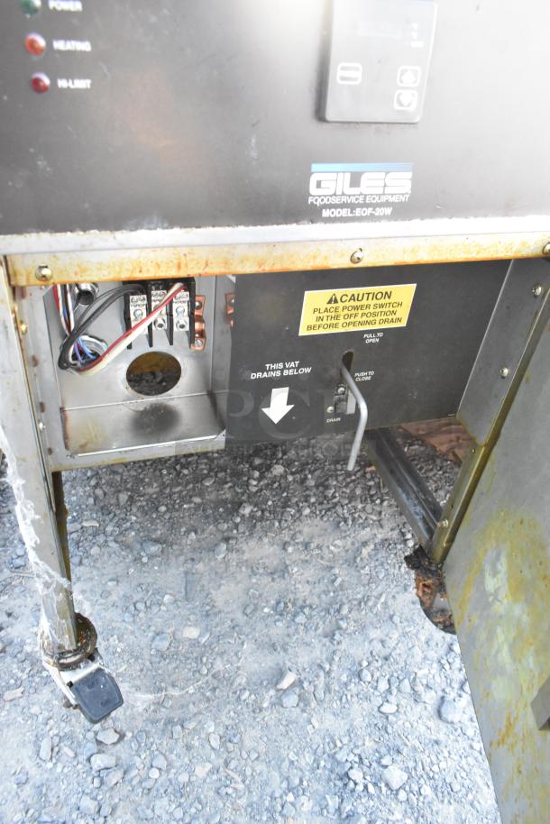 Giles EOF-24 stainless steel commercial 3-bay deep fat fryer with dumping station, on casters, 480V, 3 phase, caution label visible.