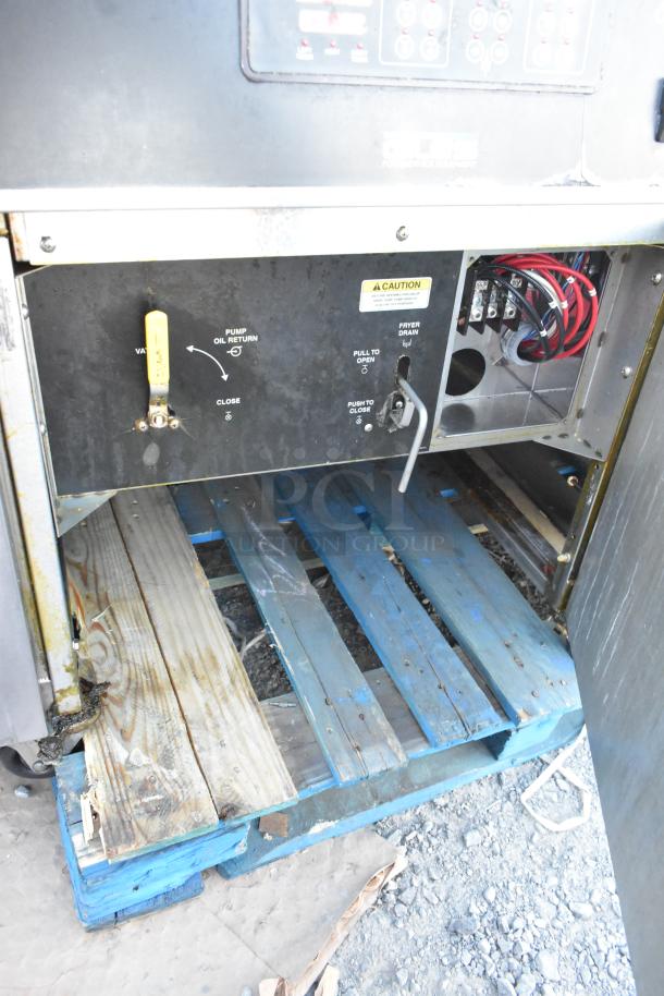 Giles EOF-24 commercial stainless steel fryer with dumping station, visible control panel, valve markings, on casters.