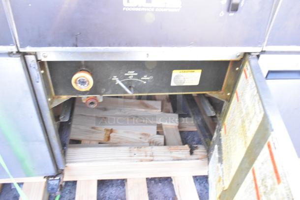 Giles EOF-24 stainless steel commercial 3-bay deep fryer with dumping station on casters, showing control panel and warning labels.