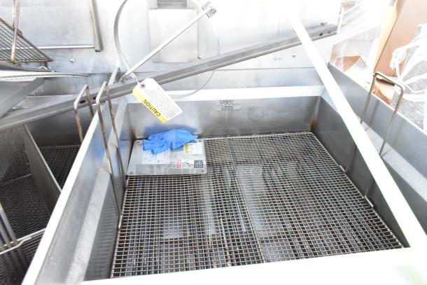 Giles EOF-24 stainless steel 3 bay deep fat fryer with dumping station, commercial casters, caution tag, 480V, 3 phase.