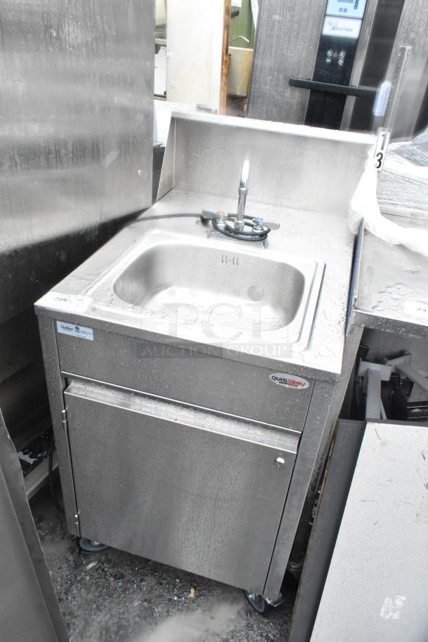 QualServ stainless steel commercial portable sink with faucet and cabinet, on commercial casters, branded with QualServ logo.