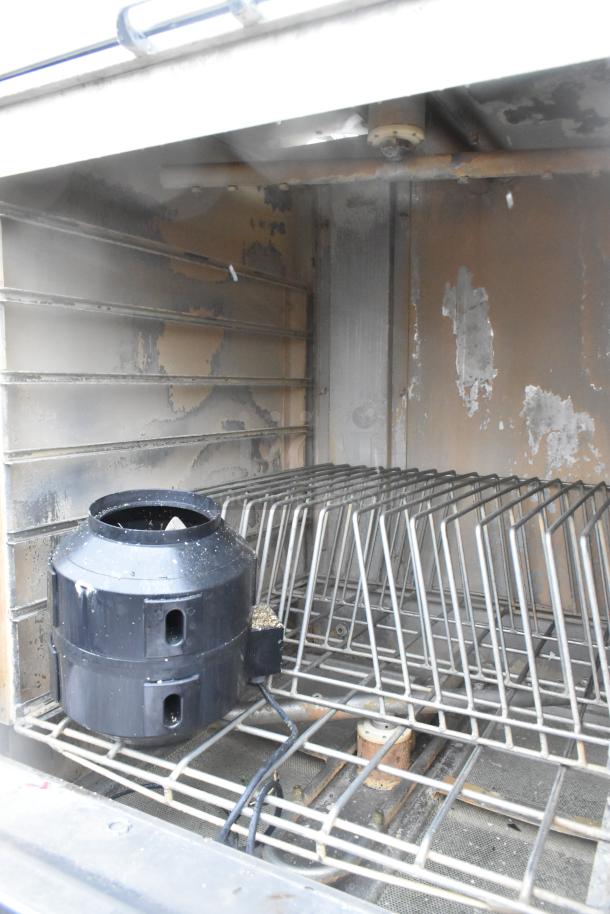 LVO stainless steel front load pot and pan washer, used condition, visible interior racks and wiring, industrial-grade.