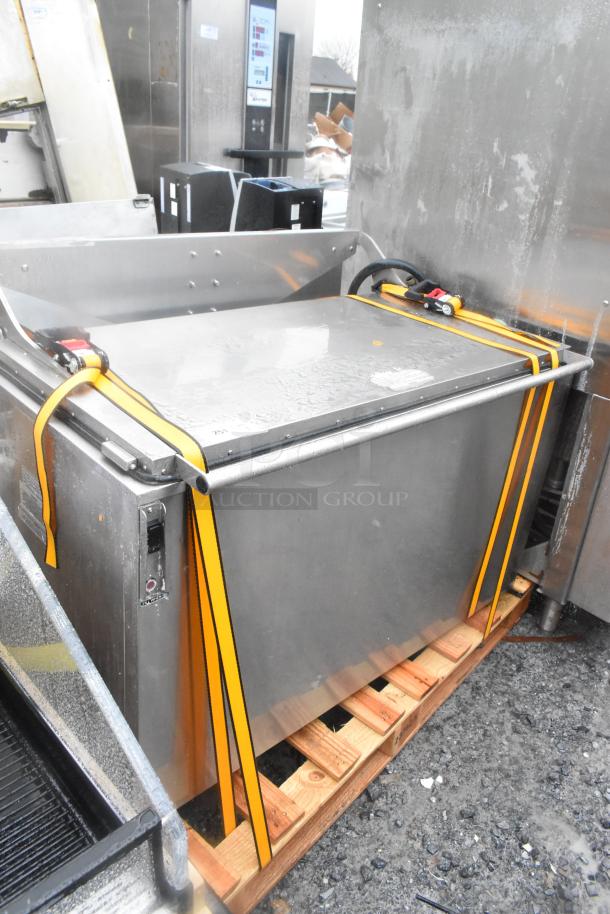 Stainless steel commercial washing/soaking tub secured with straps on a pallet, in used condition, ideal for heavy-duty cleaning.