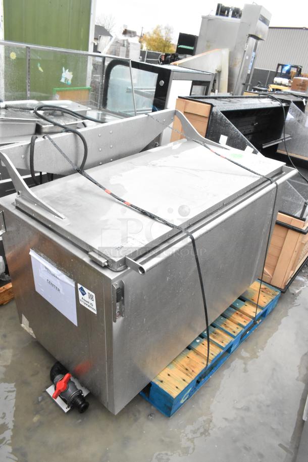 Stainless steel commercial washing/soaking tub, features a secure lid, visible pipe fittings, and various labels indicating specifications.