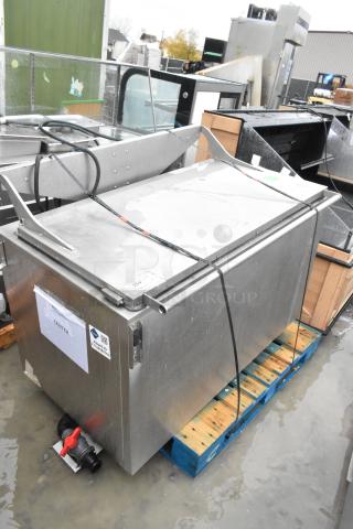 Stainless steel commercial washing/soaking tub, features a secure lid, visible pipe fittings, and various labels indicating specifications.