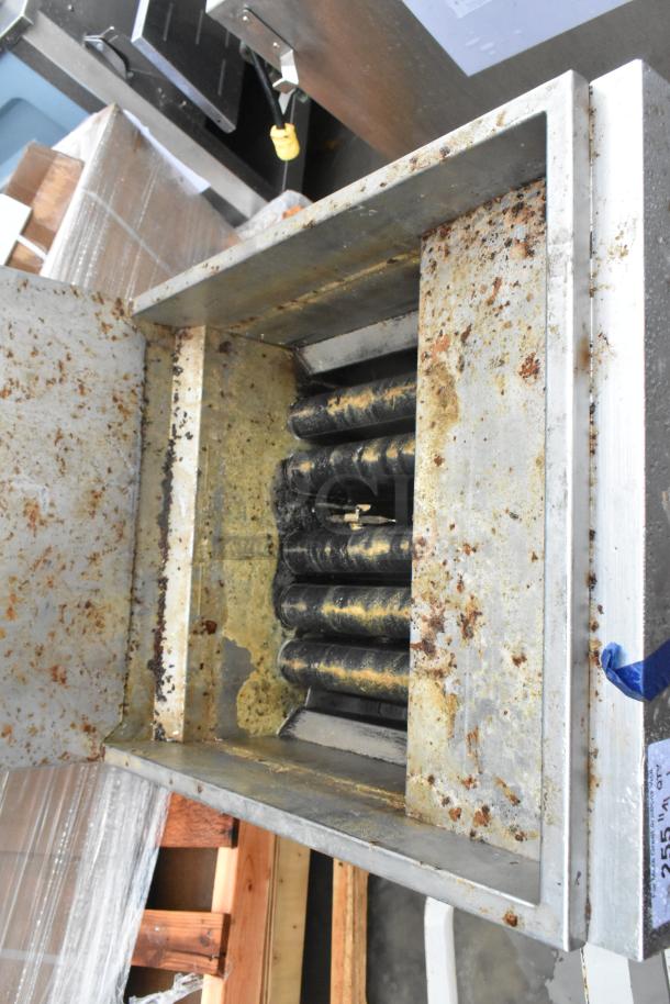 Migali stainless steel gas-powered deep fat fryer, showing interior condition with visible grease and wear, on commercial casters.