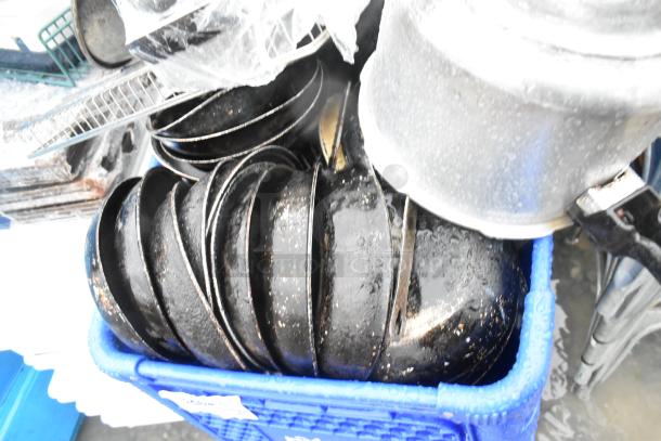 Lot of various kitchen items including potato ricer, metal skillets, and baskets. Shopping cart not included. Condition: used.