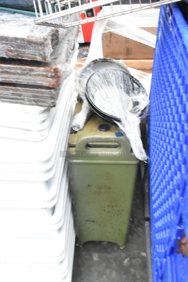 Lot includes poly white dough bins and metal baking pans, some wrapped in plastic, next to a green container and blue surface.