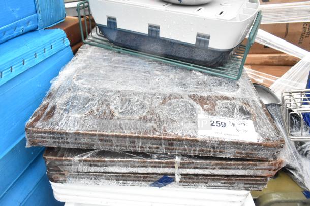 Lot of various items including metal baking pans and poly white dough bins wrapped in plastic. Auction tag reads "259".