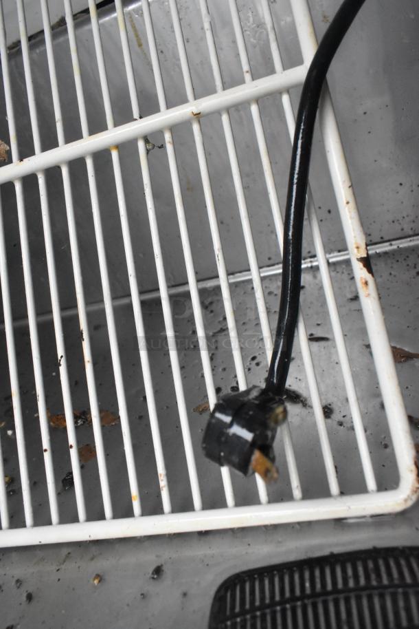 True TSSU-72-18 prep table interior showing shelf and power cord. Visible wear suggests moderate use. 115V, 1 Phase.