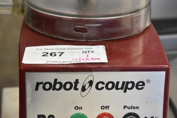 Robot Coupe R2NCLR countertop food processor with bowl and S blade, 120 volts, 1 phase, good condition, auction label visible.