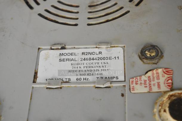 Robot Coupe R2NCLR food processor label with model, serial number, voltage, and NSF certification details.