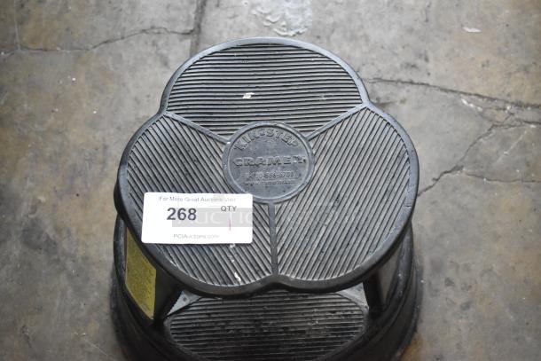 Black poly stool with ribbed surface, "Kik-Step Cramer" embossed. Auction label reads "268." Used condition.