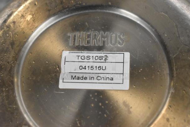 Metal pitcher with "THERMOS" branding, model TGS10S, Made in China label, shows signs of wear.