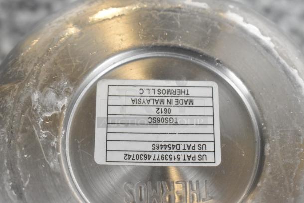 Bottom of a metal Thermos pitcher with label showing "THERMOS L.L.C., Made in Malaysia, TG506SC 0612," and US patent numbers.