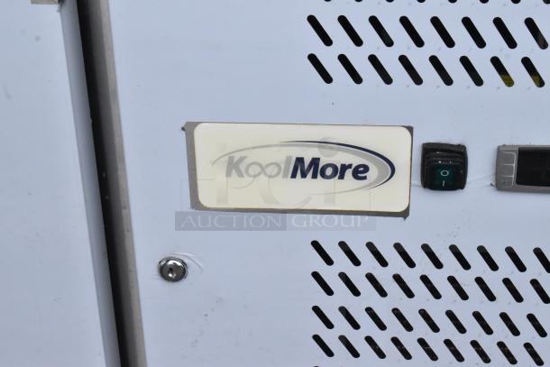 KoolMore KM-RPPS-2D59-GRT stainless steel cooler with a granite countertop. Brand label and power switch visible.