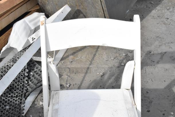 White folding chair with chipped paint and visible wear, part of a set of six items at auction.