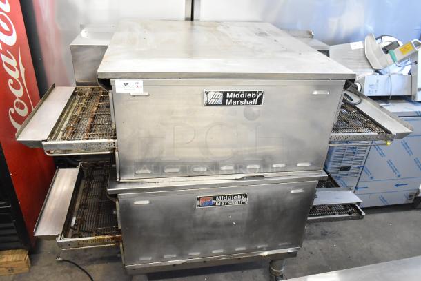 Two 2021 Middleby Marshall PS638G stainless steel conveyor pizza ovens on casters, natural gas, 89,000 BTU. Visible brand labels.