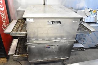Two 2021 Middleby Marshall PS638G stainless steel conveyor pizza ovens on casters, natural gas, 89,000 BTU. Visible brand labels.