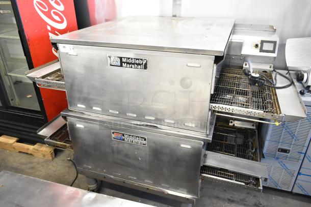 Two Middleby Marshall PS638G stainless steel conveyor pizza ovens, commercial casters, natural gas, 89,000 BTU, visible wear.