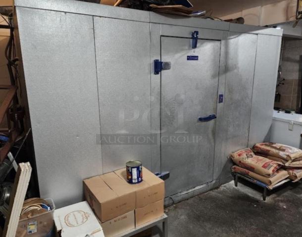 8'x10' Bally walk-in box with three compressors, silver exterior, blue door handles, in used condition, indoor setup.