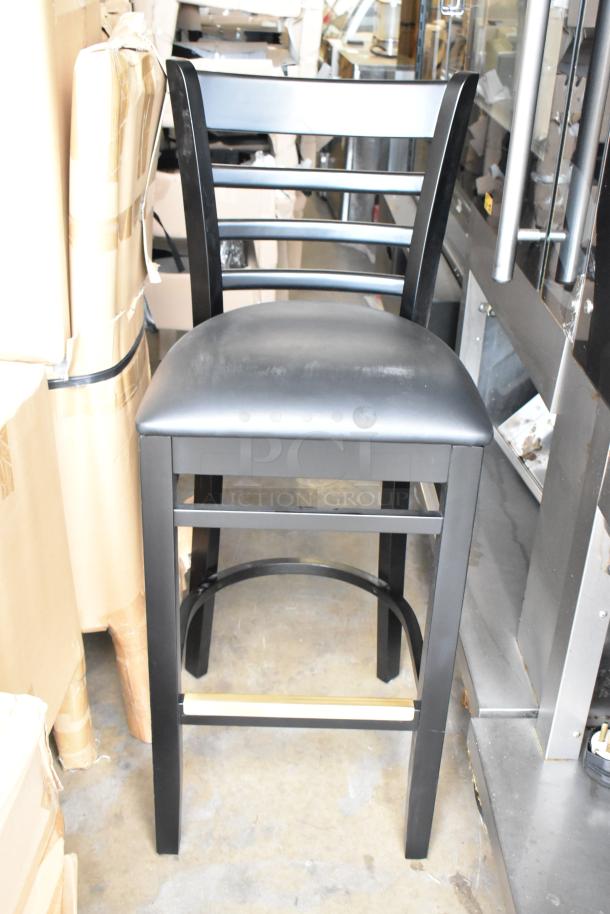 Brand new black wood pattern bar height chair with black seat cushion, scratch and dent condition, auction lot of 40.