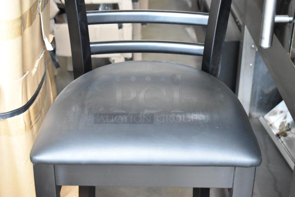 Black bar height chair with wood pattern and soft black seat cushion. Brand new with minor scratches. Auction for 40 chairs.