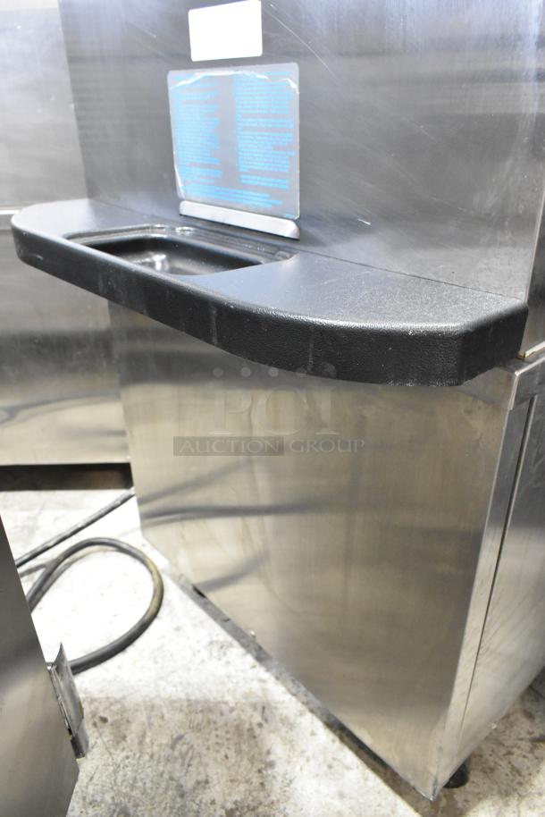 Stainless steel Taylor C723-33 two-flavor soft serve machine with twist, water cooled, on commercial casters.