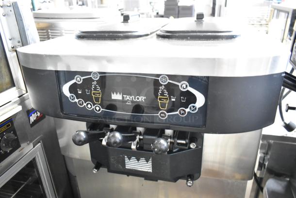Taylor C723-33 stainless steel soft serve machine, 2 flavors with twist, water-cooled, on casters, 208-230V, 3 phase.