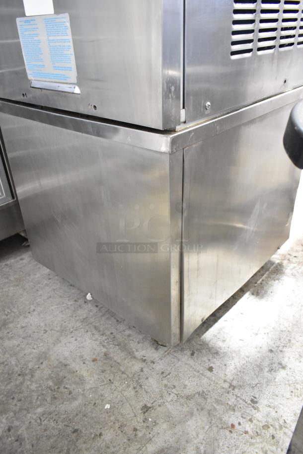 Stainless steel Taylor C723-33 commercial soft serve machine with dual flavors and twist, on casters. Visible side view.