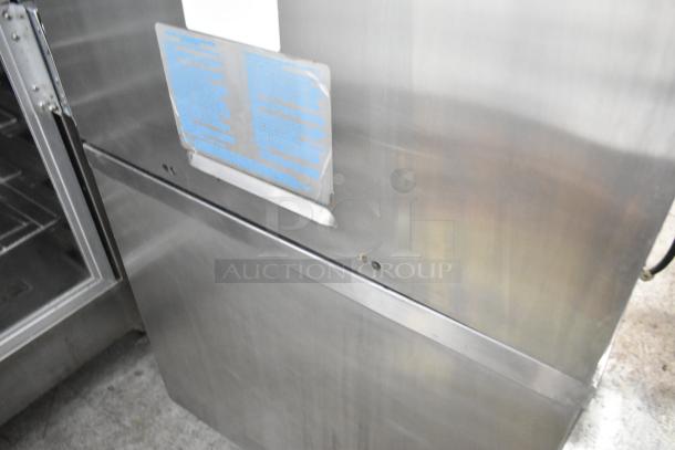Taylor C723-33 stainless steel commercial soft serve ice cream machine with visible instructions label. Water cooled, on casters.