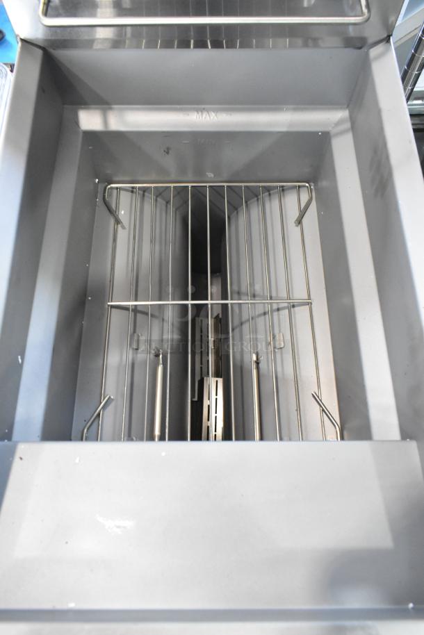 Brand new Cooking Performance Group 351FFOP40N 40 lb. stainless steel fryer, open pot design with two metal fry baskets.