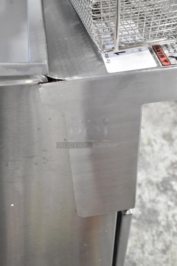 BRAND NEW SCRATCH AND DENT! 2024 CPG 351FFOP40N stainless steel 40 lb. fryer with small dent, includes 2 fry baskets.