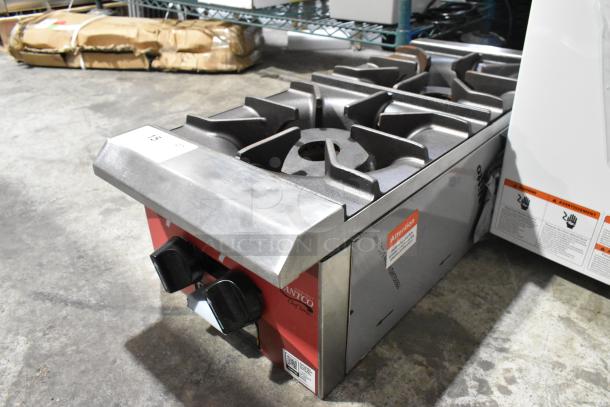 Brand new scratch and dent Avantco 177CAGR212 stainless steel 2-burner gas range, 25,000 BTU, with visible brand labels.