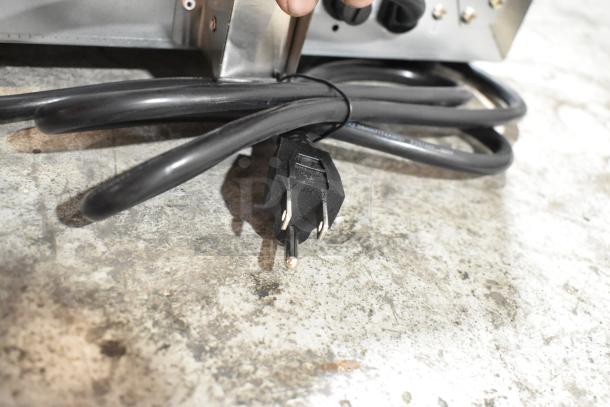 Alt text: Avantco 177CO14 convection oven power cord and plug on concrete surface. Stainless steel exterior visible.