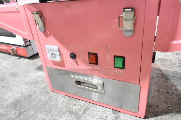 Brand new Carnival King 382CCM21CT cotton candy machine with a pink cart and 21" stainless steel bowl, missing axle.