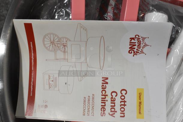 BRAND NEW Carnival King 382CCM21CT cotton candy machine with 21" stainless steel bowl, cart, missing axle; manual visible.