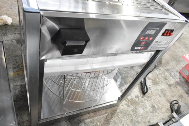 Brand new ServIt 423PDW18D1 stainless steel pizza warmer. Features 4-shelf rotating rack. Note broken glass. 120V, 1 Phase.