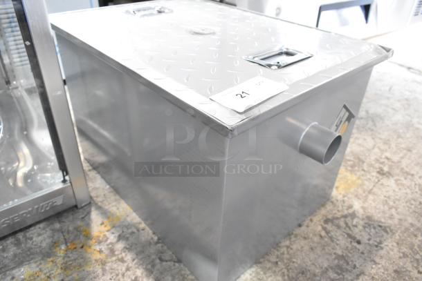 Brand new Regency 600GT15 30 lb. grease trap, 15 GPM, with 2" non-threaded connections, visible scratch and dent.