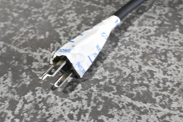 Close-up of a plug for a 2025 Bunn VPR-APS stainless steel pourover coffee brewer, wrapped in protective covering.