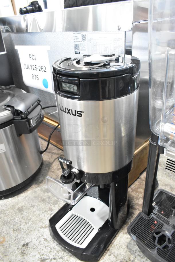 BRAND NEW 2025 Fetco L4D-15 Luxus 1.5 Gallon Stainless Steel Coffee Server with Stand, minor scratches visible.