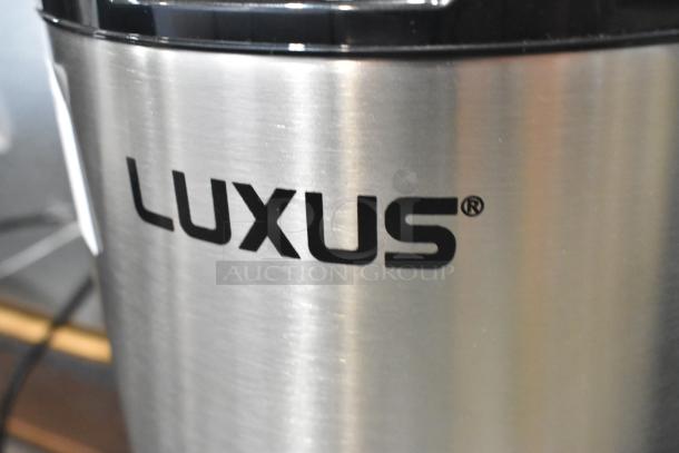 BRAND NEW Fetco L4D-15 Luxus 1.5 Gallon stainless steel coffee server with stand, visible LUXUS logo, scratch and dent condition.